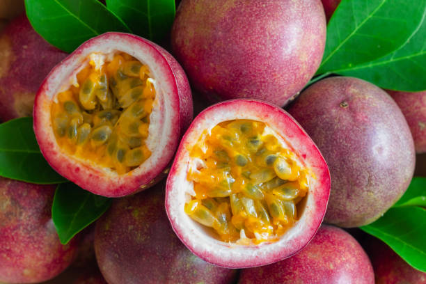 istock Fresh passion fruit on wood table in top view flat lay for background or wallpaper. Ripe passion fruit so delicious sweet and sour. Close up on a half of passion fruit in macro concept.Tropical fruit. 860079962