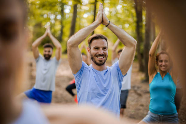 istock Young happy man exercising on Yoga class in nature. 860081340