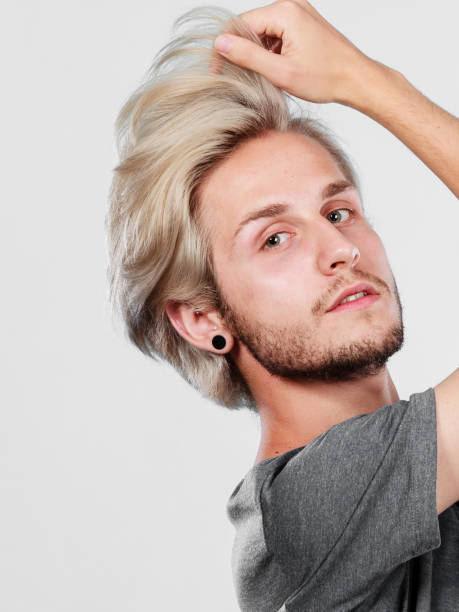 istock Blonde handsome guy touching his hair 860081514