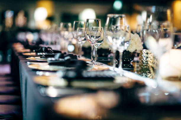 istock Luxury table settings for fine dining with and glassware, beautiful blurred  background. Preparation for holiday  Christmas and Hannukah dinner night. 860082096