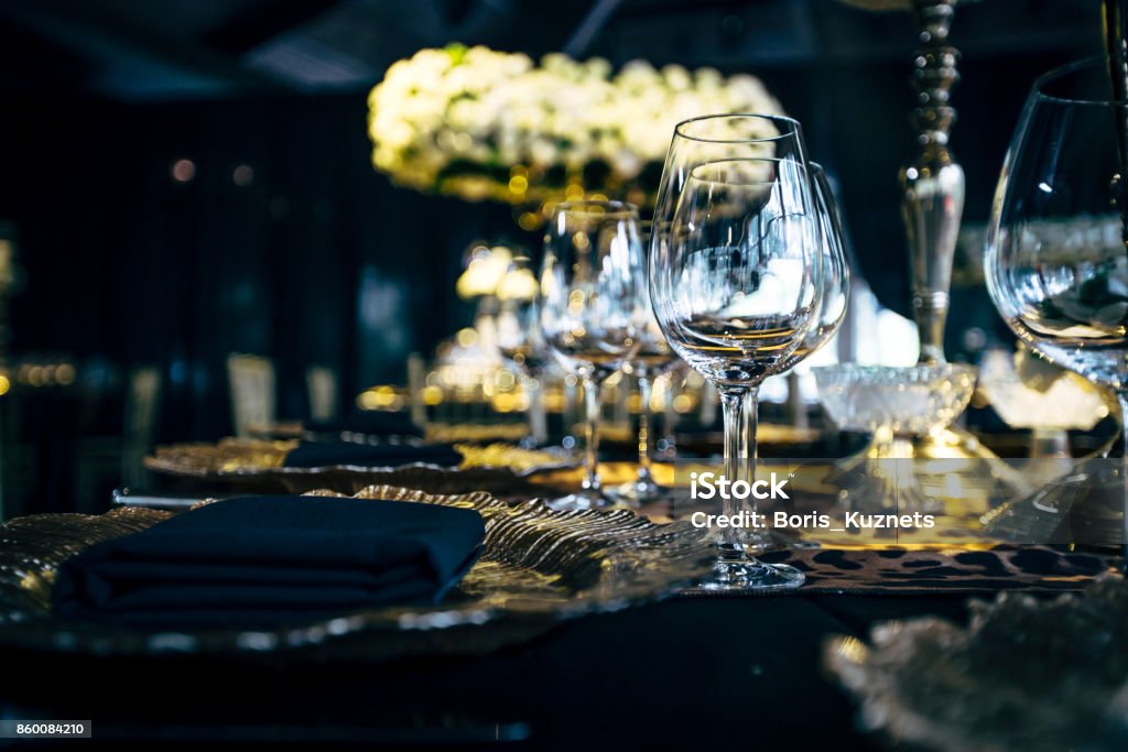 Luxury table settings for fine dining with and glassware, beautiful blurred  background. Preparation for holiday  Christmas and Hannukah dinner night. Arts Culture and Entertainment Stock Photo