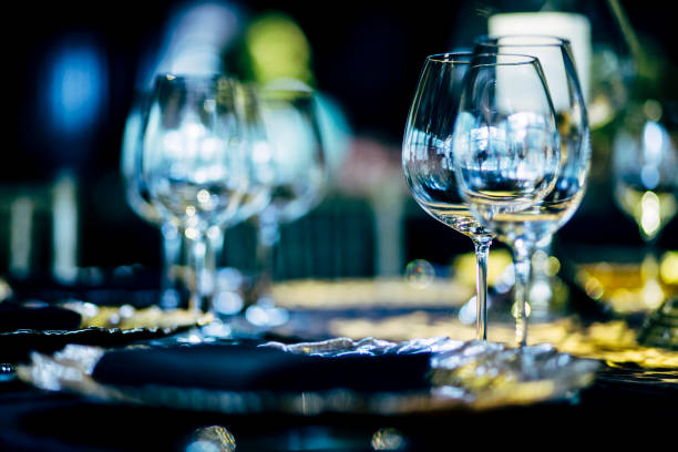 istock Luxury table settings for fine dining with and glassware, beautiful blurred  background. Preparation for holiday  Christmas and Hannukah dinner night. 860084608