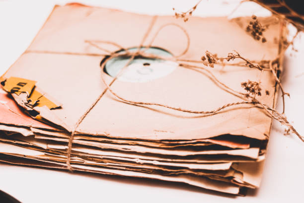 istock Stack of scratched dusty old vinyl records tied with rope on white background 860085248