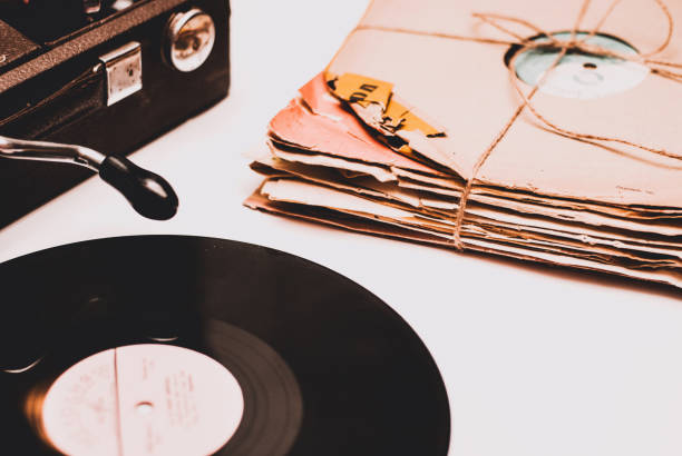 istock Stack of scratched dusty old vinyl records tied with rope on white background 860085702