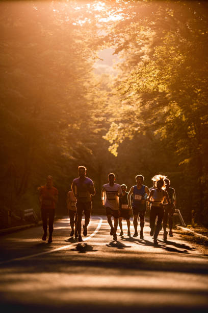 istock Group of athletes running a marathon in nature at sunset. 860087880