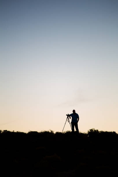 istock Silhouette of a photohrapher at dusk 860088020