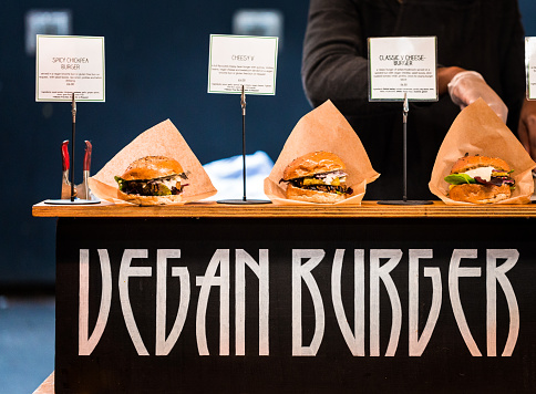 Freshly flame grilled Vegan burgers displayed in a row