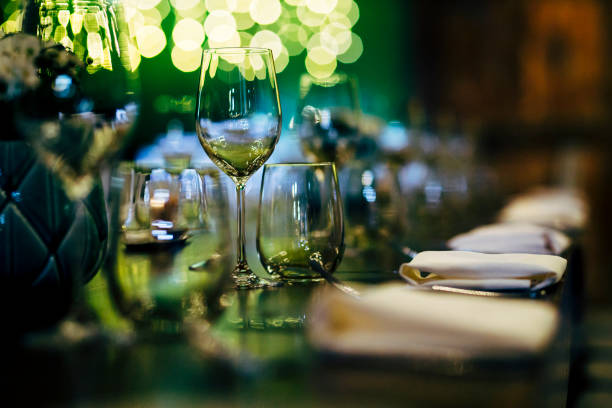 istock Luxury table settings for fine dining with and glassware, beautiful blurred  background. Preparation for holiday  Christmas and Hannukah dinner night. 860088480