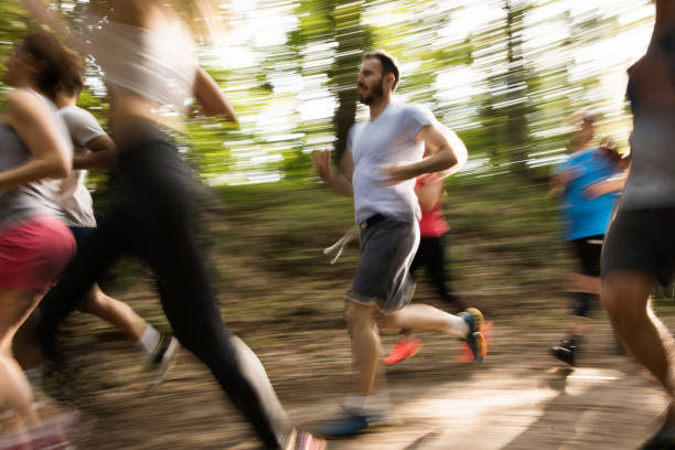 istock Marathon runners in blurred motion running through the forest. 860089126