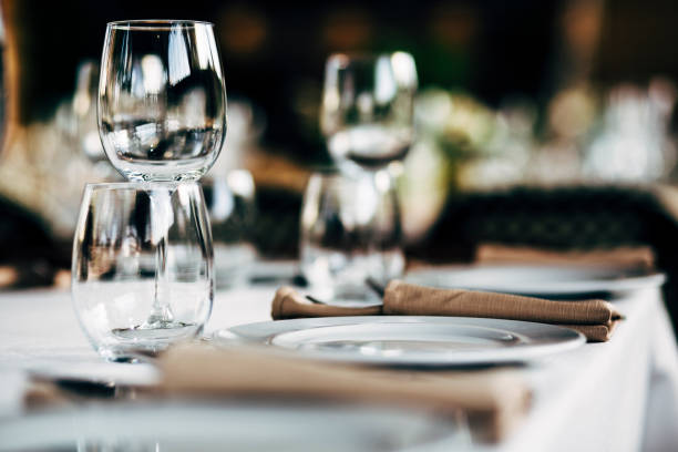istock Luxury table settings for fine dining with and glassware, beautiful blurred  background. Preparation for holiday  Christmas and Hannukah dinner night. 860089206
