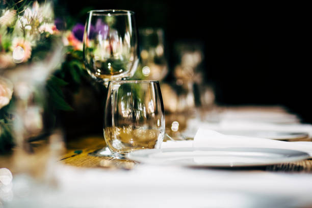 istock Luxury table settings for fine dining with and glassware, beautiful blurred  background. Preparation for holiday  Christmas and Hannukah dinner night. 860089408