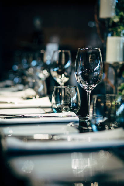 istock Luxury table settings for fine dining with and glassware, beautiful blurred  background. Preparation for holiday  Christmas and Hannukah dinner night. 860089474