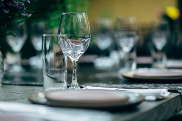 istock Luxury table settings for fine dining with and glassware, beautiful blurred  background. Preparation for holiday  Christmas and Hannukah dinner night. 860089570