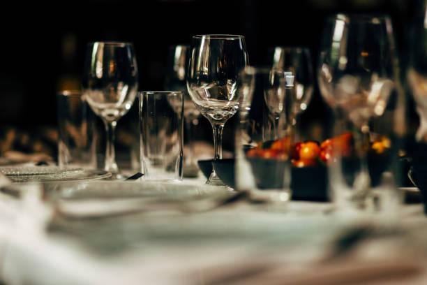 istock Luxury table settings for fine dining with and glassware, beautiful blurred  background. Preparation for holiday  Christmas and Hannukah dinner night. 860089660