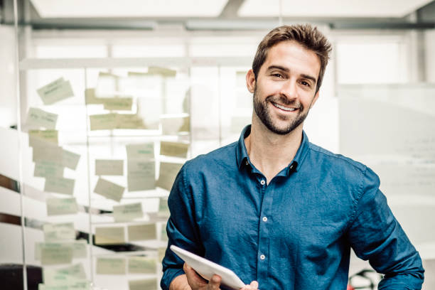 istock Smiling businessman holding digital tablet 860089784