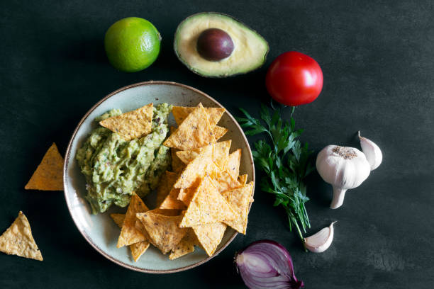 istock Plate of guacamole with tortilla chips and ingredients 860089928