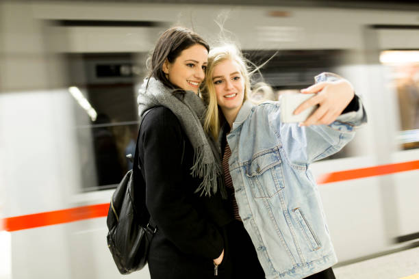 istock Young women taking selfie in subway 860089958