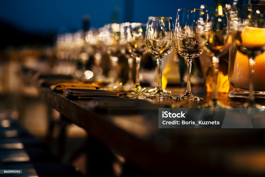 Luxury table settings for fine dining with and glassware, beautiful blurred  background. Preparation for holiday  Christmas and Hannukah dinner night. Arts Culture and Entertainment Stock Photo