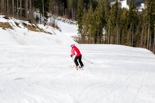 istock skier is skiing down the slope in the woods 860093100