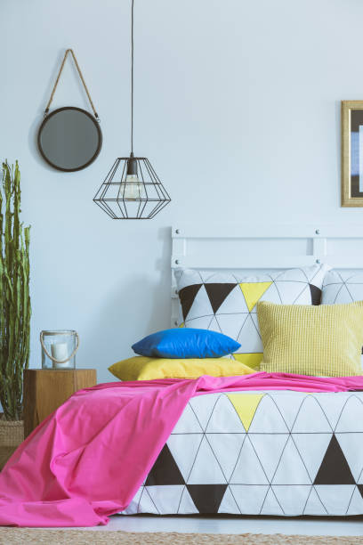 istock Pink coverlet in colorful bedroom 860097376