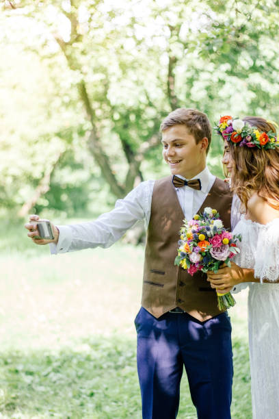istock Young couple - bride and groom making selfie during wedding ceremony. 860100212