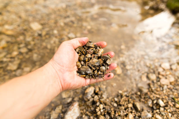istock Small stones in the hand on the pond 860100828