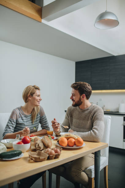 istock Young smiling couple communicating and enjoying in breakfast time at home. 860101416