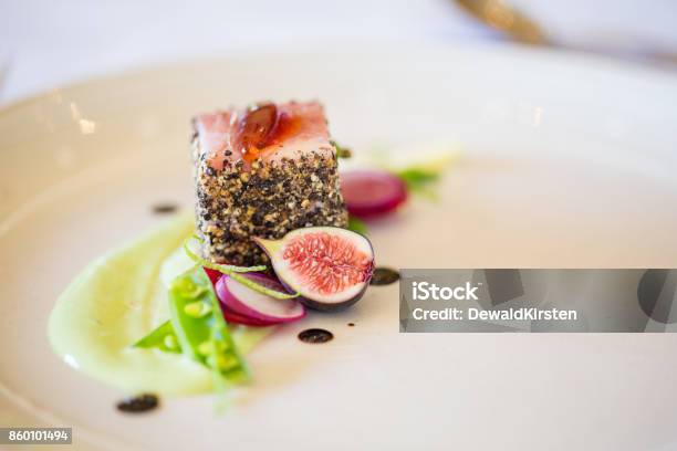 Gourmet Pork Dish Covered In Crushed Black Pepper With Green Figs On The Side Stock Photo - Download Image Now