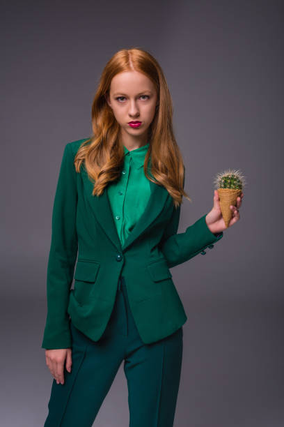 istock attractive girl with cactus 860104696