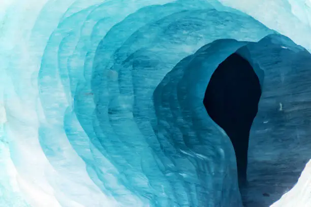 Photo of Abstract view of the entrance of an ice cave in the glacier Mer de Glace, in Chamonix Mont Blanc Massif, The Alps, France