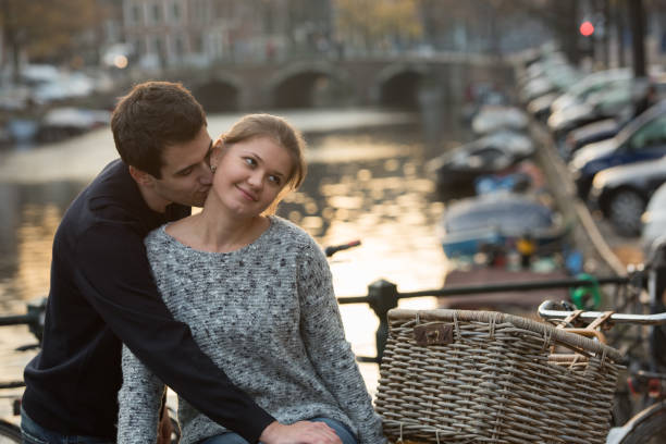 istock lovers in Amsterdam at sunset 860105524