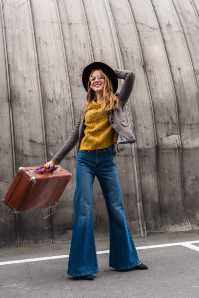 stylish girl in hat with suitcase elegant stylish redhead girl in fedora hat holding vintage suitcase alternative pose photos stock pictures, royalty-free photos & images