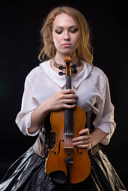 istock Blond girl with the violin and looking down 860113302