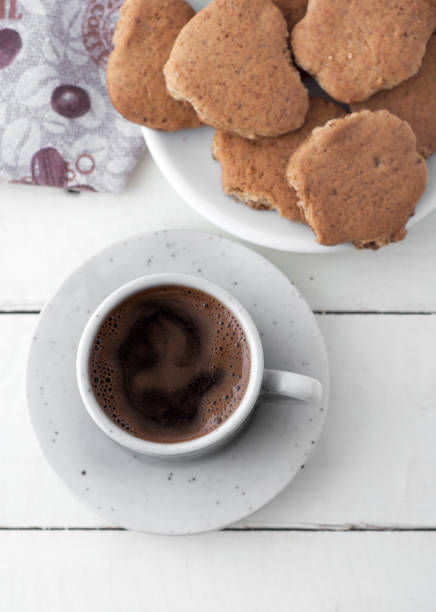 istock Coffee and cookies on white wooden table 860117268