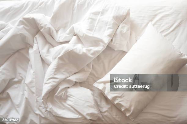 Messy Bed White Pillow With Blanket On Bed Unmade Top View Stock Photo - Download Image Now