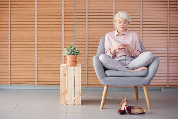 istock Smart woman sitting armchair and reading a text message 860119704