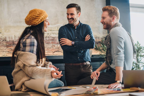 istock Young happy freelance workers communicating at casual office. 860120530