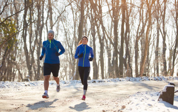 istock Young couple running in forest 860122540