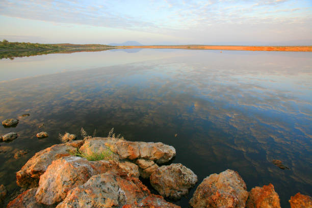 istock Sunset clouds reflected on Lake Magadi's surface, Great Rift Valley, Kenya 860122632