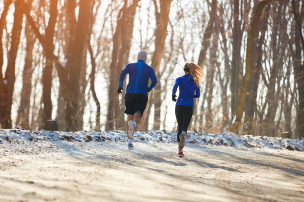 istock Two persons jogging in nature together 860122834