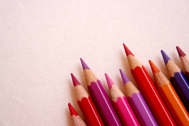 istock Red colored pencils over a pink background. 860125902