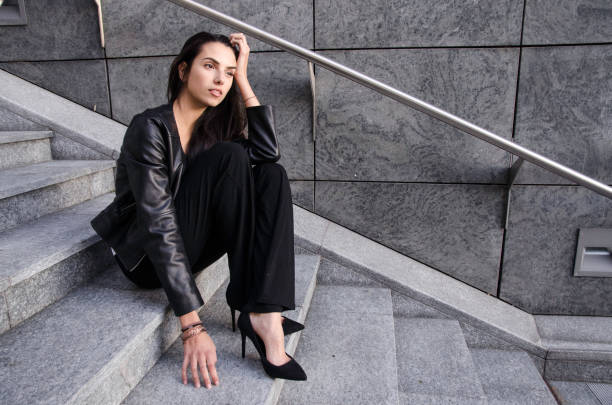 istock Fashion Model sitting on the stairs 860126384