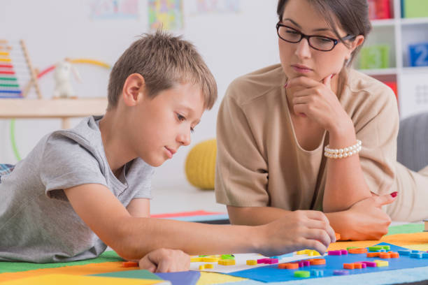 istock Focused boy and pretty psychotherapist 860126604