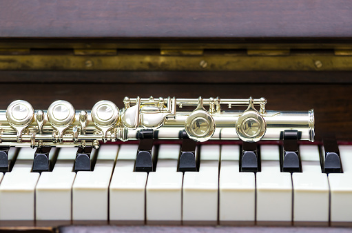 Closeup Flute on the keyboard of piano, musical instrument