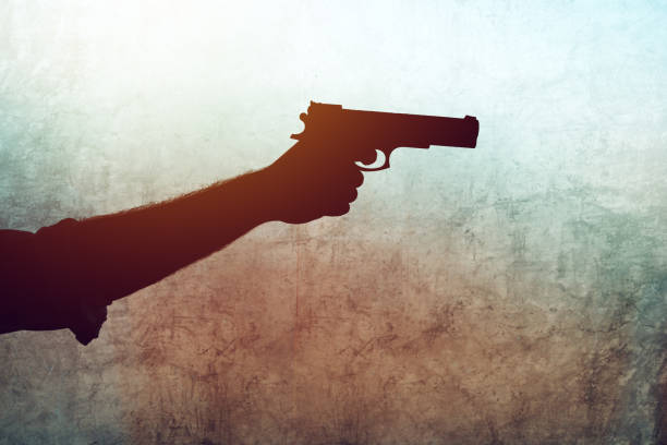 istock Hand with a gun on grunge background 860133064