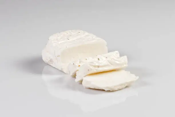 Sliced halloumi cheese with mint isolated on white
