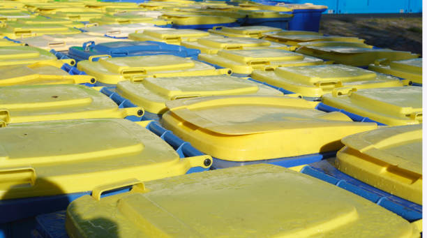 istock Yellow and blue tons, recyclable material bins, lids 860136452