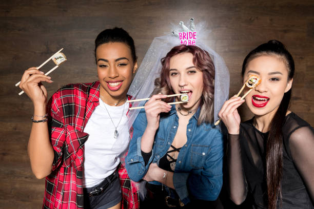 istock multicultural women with sushi at hen party 860136984