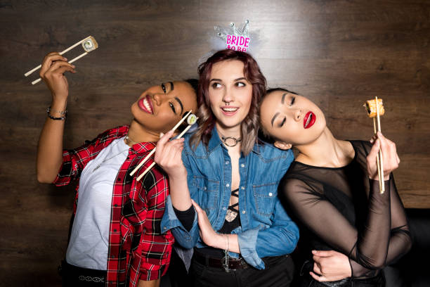 istock multicultural women with sushi at hen party 860137604