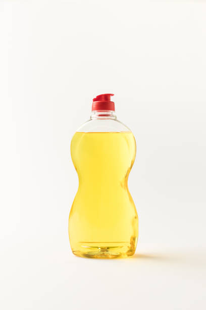 close-up view of plastic bottle of yellow cleaning fluid isolated on white
